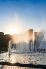 The large fountain against the backdrop of the setting sun.