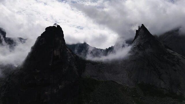 flying over rocks in the form of a parabola in the clouds