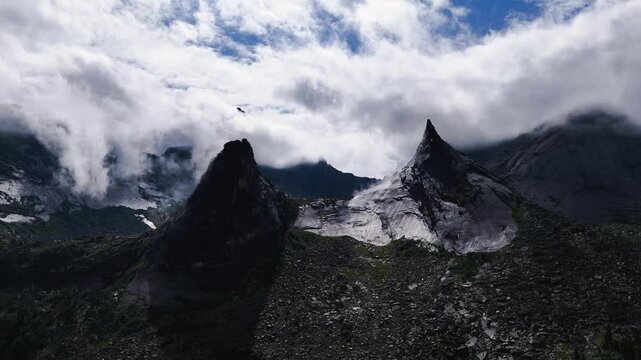 flying over rocks in the form of a parabola in the clouds