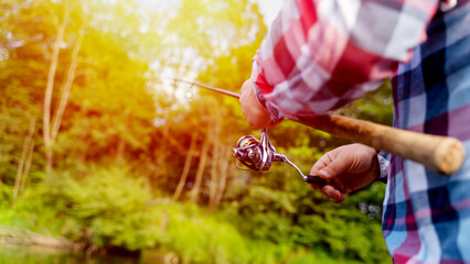 A man fishing with a spinning rod catches fish from a boat