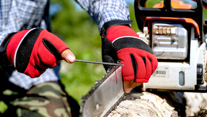 master sharpens a chain on a chainsaw