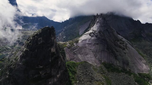 flying over rocks in the form of a parabola in the clouds