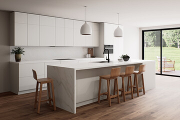 A beautiful modern kitchen interior featuring abundant natural light and a spacious, open layout