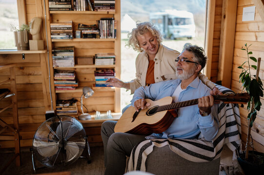 Middle-aged couple enjoying time together in wooden house closeup.