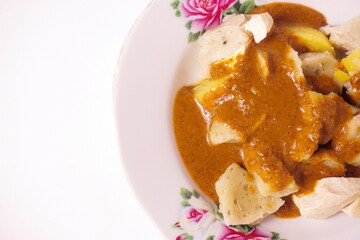 a siomay with fish balls, potatoes, peanut sausage, and tofu on a white background isolated