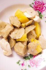 a siomay with fish balls, potatoes and tofu on a white background isolated