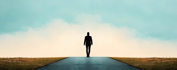 Silhouette of a man walking down a road against a dramatic sky.