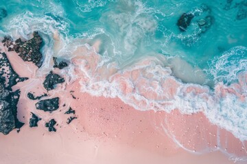 Obraz premium Aerial View of Serene Tropical Beach with Pink Sand and Turquoise Waves Gently Crashing on Rocky Shoreline, Capturing Natures Tranquil Beauty.