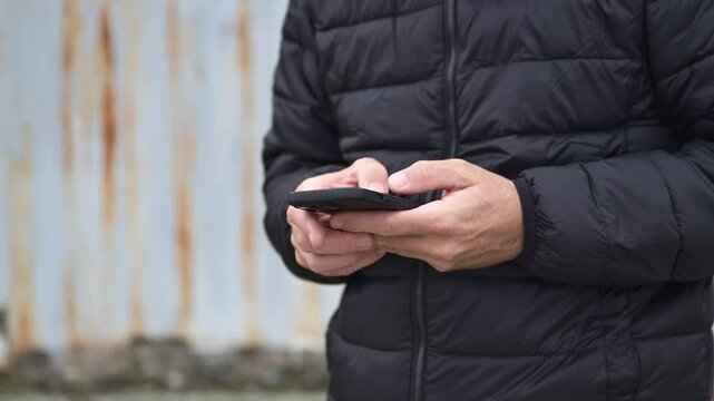 Mobile phone roaming and eSIM concept, mature adult man using smartphone outdoors, 4K