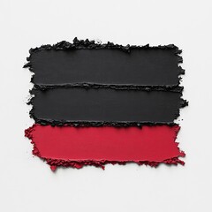 Abstract paint swatches in black and red on a white background.