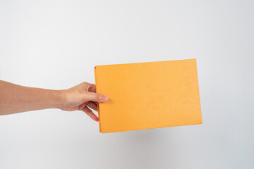 Blank book cover in hand on white background.