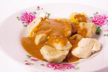 a siomay with fish balls, potatoes, peanut sausage, and tofu on a white background isolated