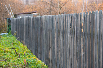 Wooden fence made of grey picket fence.