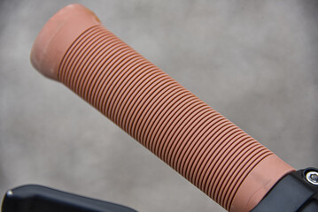 The scooter's rubber handle is beige.