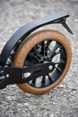 The rear wheel of the scooter has a disc and foot brake.