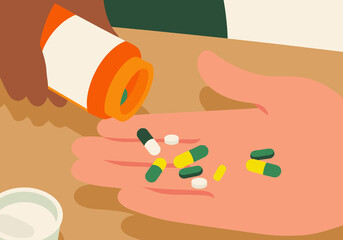 Various pills and capsules are being poured from prescription bottle