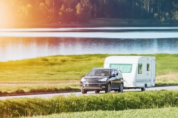 SUV pulling a caravan in nature
