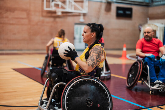 Disabled athletes sitting in wheelchair and playing rugby
