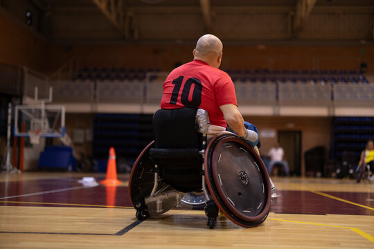 Disabled rugby player sitting in wheelchair at court