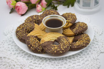 Round Chocolate Cookies with Coffee on White Plate