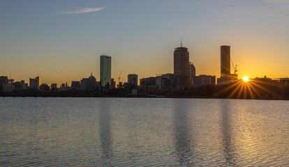 Naklejka premium Boston skyline at sunset with river reflections.