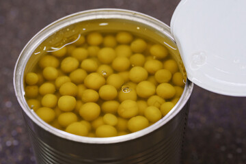 Close-up of canned green peas in a can. ingredient for cooking.