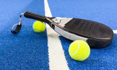 paddle tennis rackets and balls on court