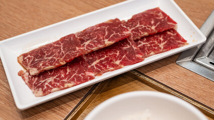Delicious fresh raw juicy kobe wagyu marbled beef pork meat slice on plate ingredient for food sukiyaki yakiniku steak healthy meal Japanese traditional dining culture restaurant high protein bar-b-q