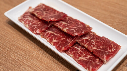 Delicious fresh raw juicy kobe wagyu marbled beef pork meat slice on plate ingredient for food sukiyaki yakiniku steak healthy meal Japanese traditional dining culture restaurant high protein bar-b-q