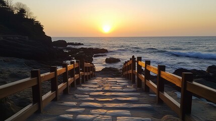 Obraz premium The stone steps leading to the sea in Haeundungang City, Korea at sunset, are surrounded by rocks and waves crashing against them. 