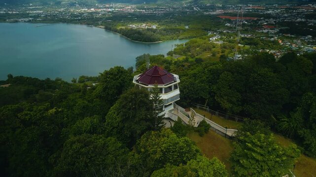 Khao Khad views tower with stairs to hill top with wild exotic jungles aerial view. Famous tourist attraction of Phuket Panwa viewpoint at twilight. Place to enjoy panoramic landscape