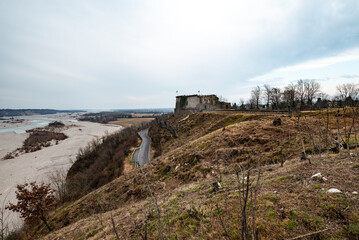 Fototapeta premium The creepy germanic shrine of Pinzano al Tagliamento, the far riverbed and the steep road running through the forested hills to the ossuary