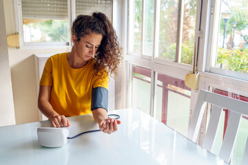 Worried Middle-Aged Woman Checking Blood Pressure at Home Living Room