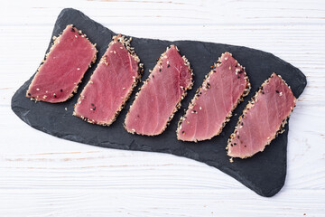 Sliced tuna steak with sesame photography . Top view