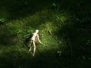 公園の芝生と可愛い疲れたマネキン人形の姿