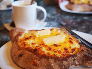 breakfast with coffee and Khachapuri, traditional Georgian dish of cheese-filled bread, close-up