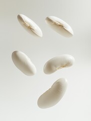 Floating white kidney beans isolated against a white background. Perfect for concepts related to healthy food, plant-based protein, and vegetarian diets.