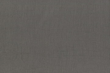The texture of natural denim dense gray fabric. Abstract background of coarse burlap. Natural denim fabric.