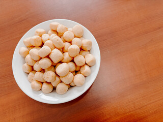 Amplang Crackers in a White Bowl on Wooden Table