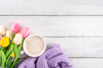 Spring coffee background with flowers and knitted sweater