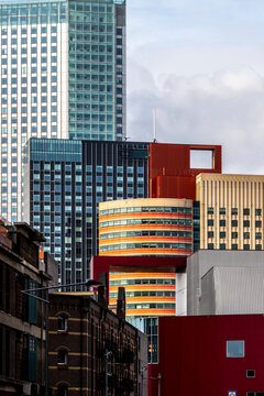 A striking cluster of vibrant and colorful skyscrapers amidst a modern cityscape, capturing the essence of urban dynamism and contemporary architectural flair in Rotterdam
