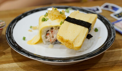 Japanese food - Tamago egg nigiri isolated on white dish.