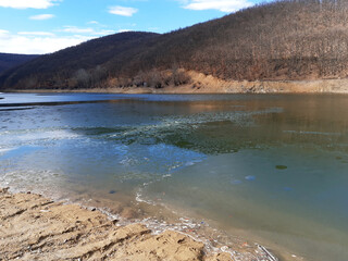 Frozen lake in the mountains in autumn