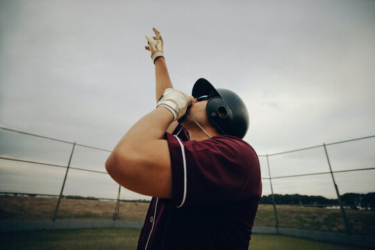 Baseball player kissing necklace as part of a superstition ritual on the field