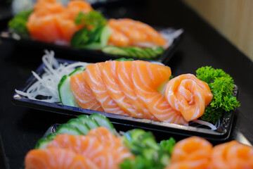 Salmon sashimi in plastic box packaging tray ready to eat.