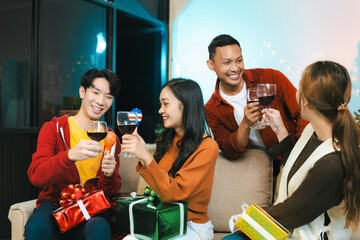 drinks and conversation, social gathering and get together at New Year young people, group and gift exchange at the event, celebration at home.