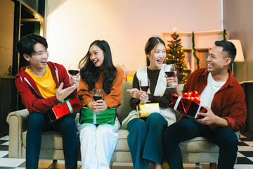 drinks and conversation, social gathering and get together at New Year young people, group and gift exchange at the event, celebration at home.