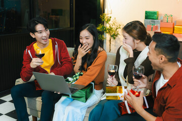 drinks and conversation, social gathering and get together at New Year young people, group and gift exchange at the event, celebration at home.