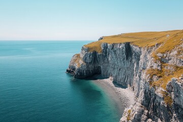 Expansive cliffs unveil a secluded beach nestled beneath, offering a picturesque view of nature's...