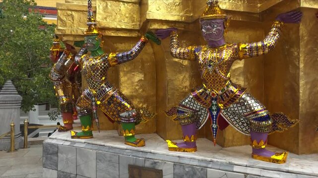 Giant guardians holding golden wall at wat phra kaew